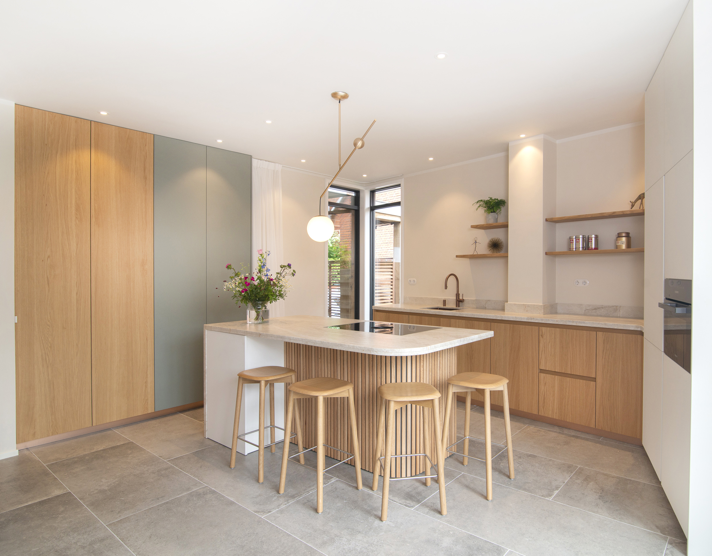 Fotografie van designkeuken met houten kasten en marmeren werkblad.